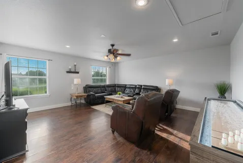 a living room with furniture window and wooden floor