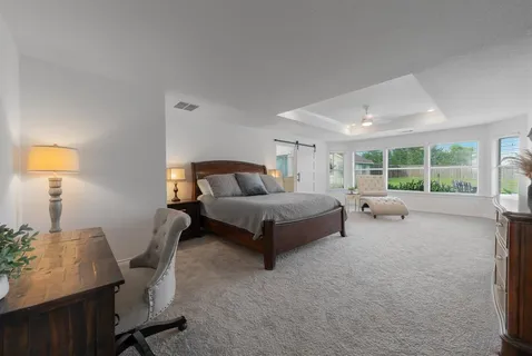 a bedroom with a bed chair and window