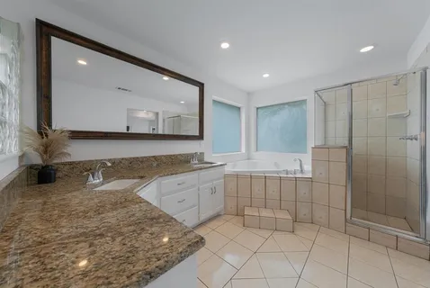 a large bathroom with a sink and a large mirror