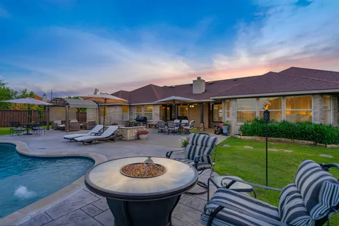 a view of a patio with swimming pool table and chairs