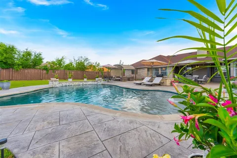 a view of swimming pool in front of house