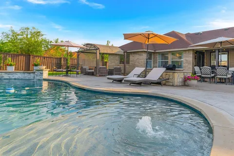 a view of a house with swimming pool and porch