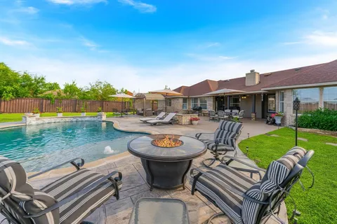 a view of a patio with dining table and chairs with a swimming pool