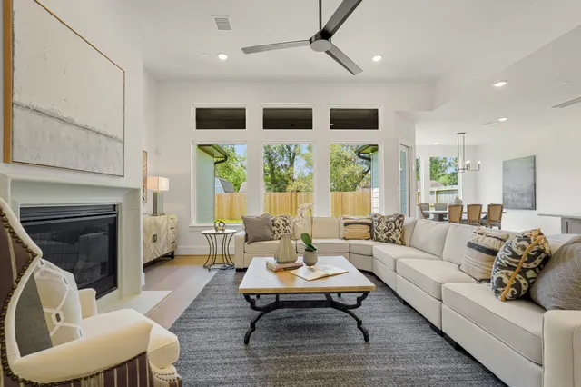 a living room with furniture fireplace and a large window