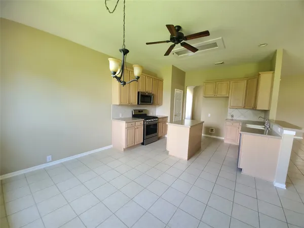 a kitchen with kitchen island white cabinets and stainless steel appliances