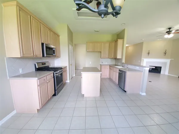 a kitchen with a stove top oven cabinets and a refrigerator