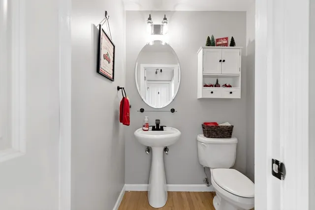 a bathroom with a sink toilet and a mirror