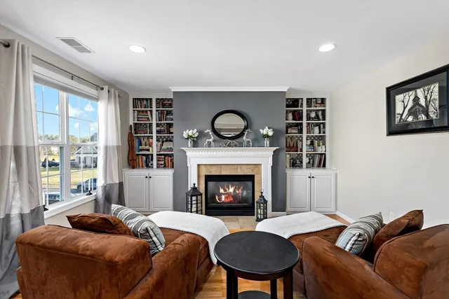a living room with furniture and a fireplace