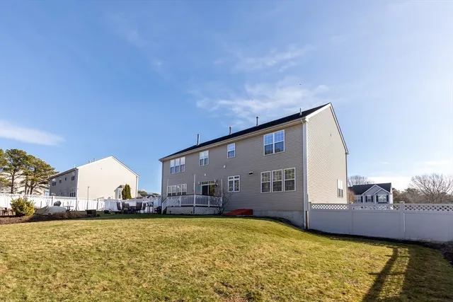 a view of a house with backyard and swimming pool