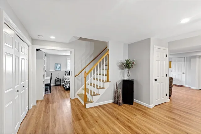 a view of entryway with wooden floor and stairs