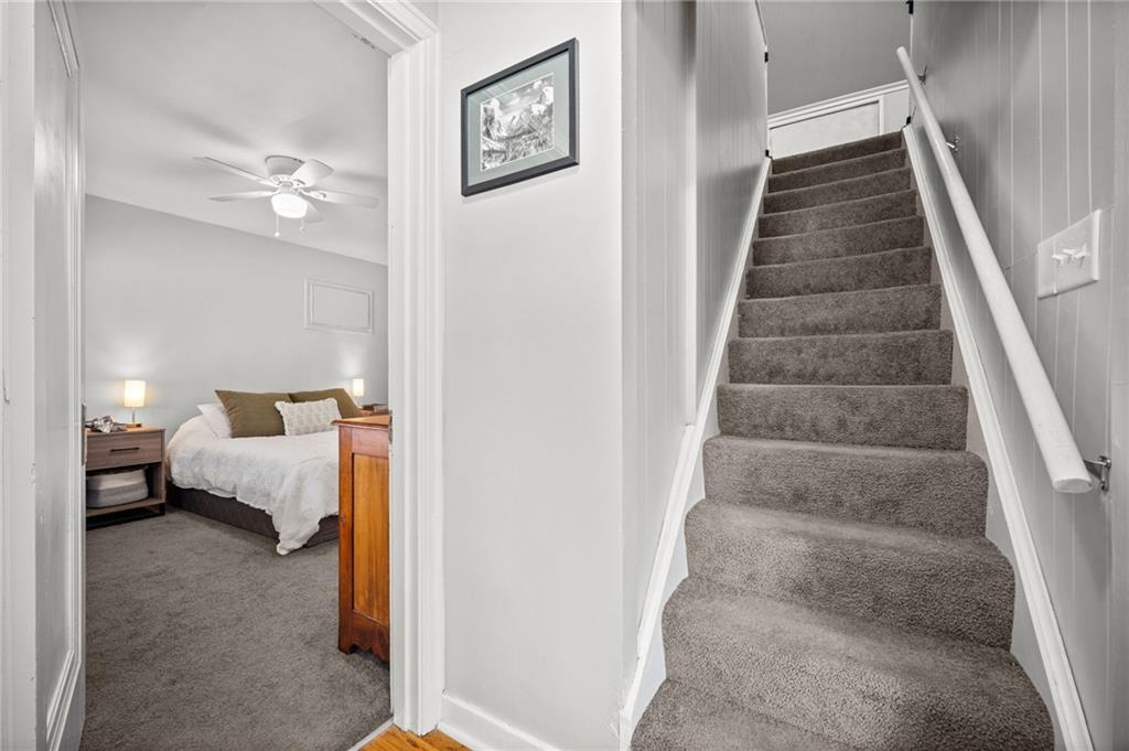 416 Phillips Avenue McKees Rocks, PA 15136 - Photo 27 of 46 a view of bedroom with stairs and wooden floor