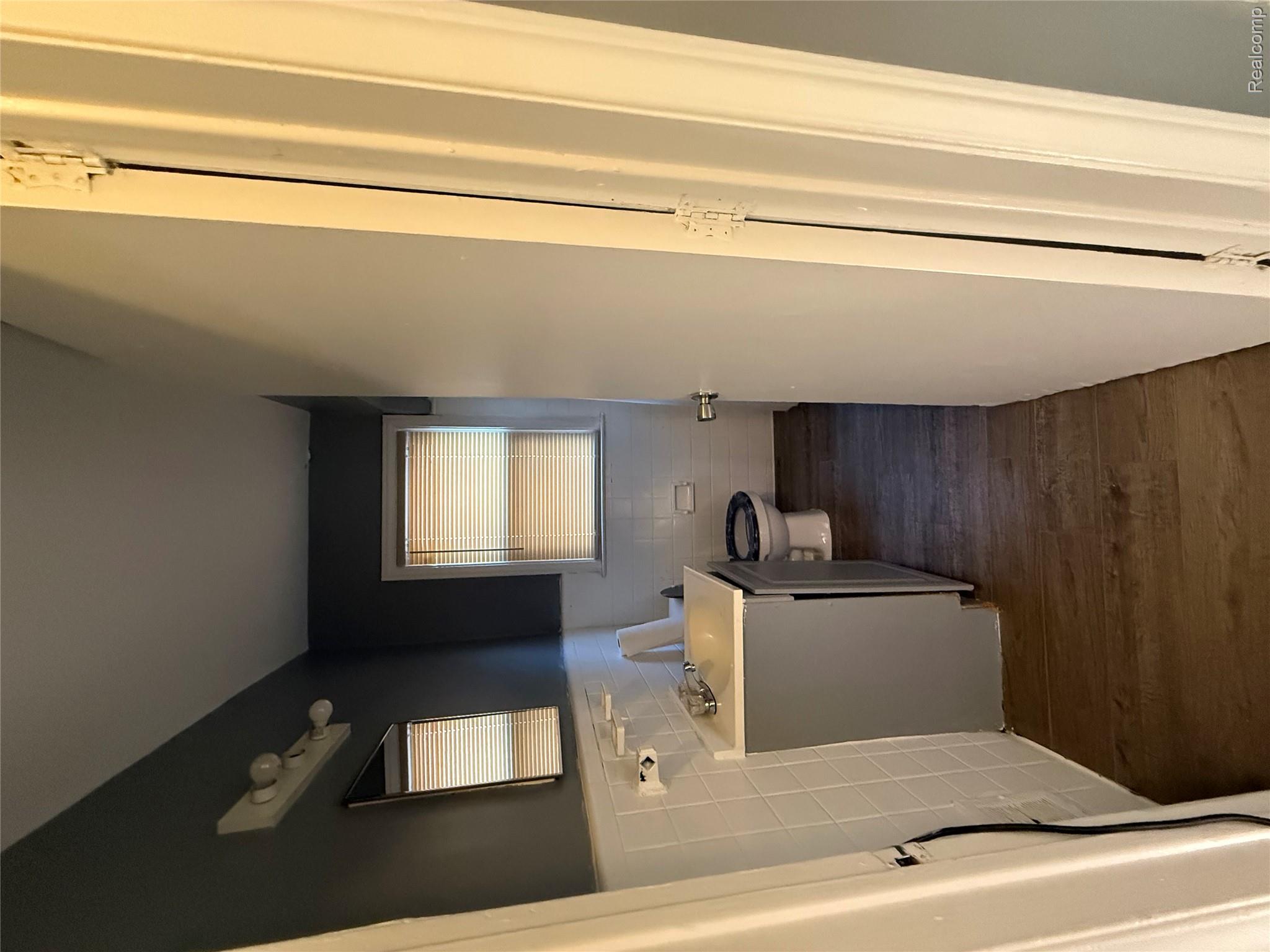 7633 Fielding Street Detroit, MI 48228 - Photo 4 of 12 Compact full bathroom featuring a vanity with integrated sink, a toilet, and wood-finish flooring