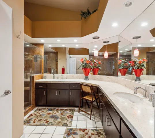 a bathroom with a sink vanity and a mirror