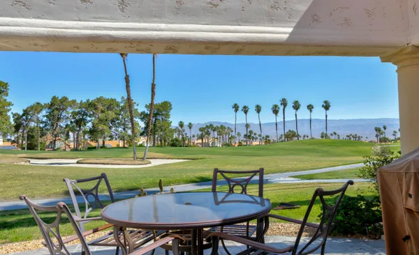 a view of a chairs and table on the deck