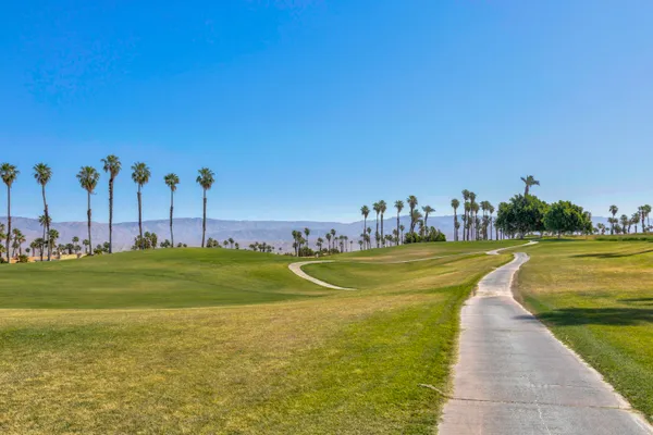 a view of a swimming pool with outdoor seating and yard