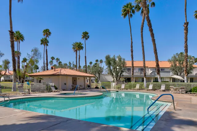 a view of swimming pool with a table and chairs