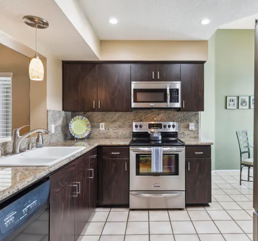 a kitchen with a sink stove and microwave