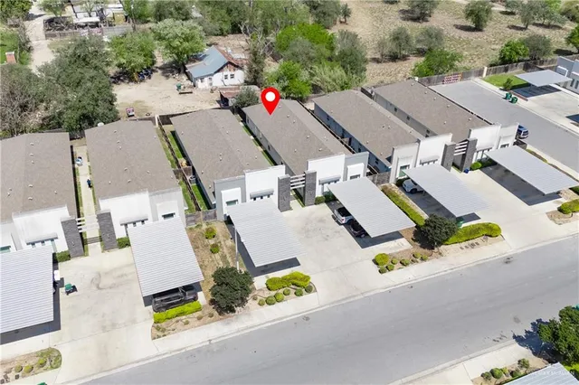 an aerial view of residential houses with refrigerator and road