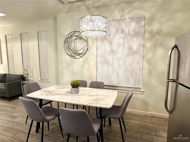 a view of a dining room with furniture and a chandelier