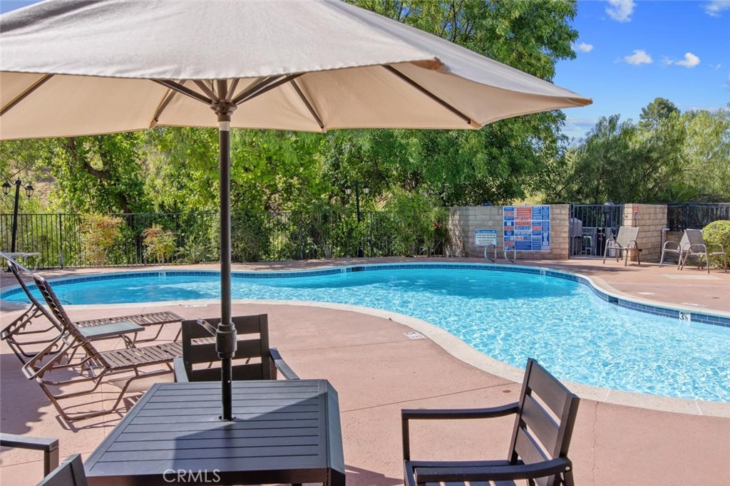 5974 Ruthwood Drive Calabasas, CA 91302 - Photo 25 of 30 a view of a patio with a table chairs under an umbrella