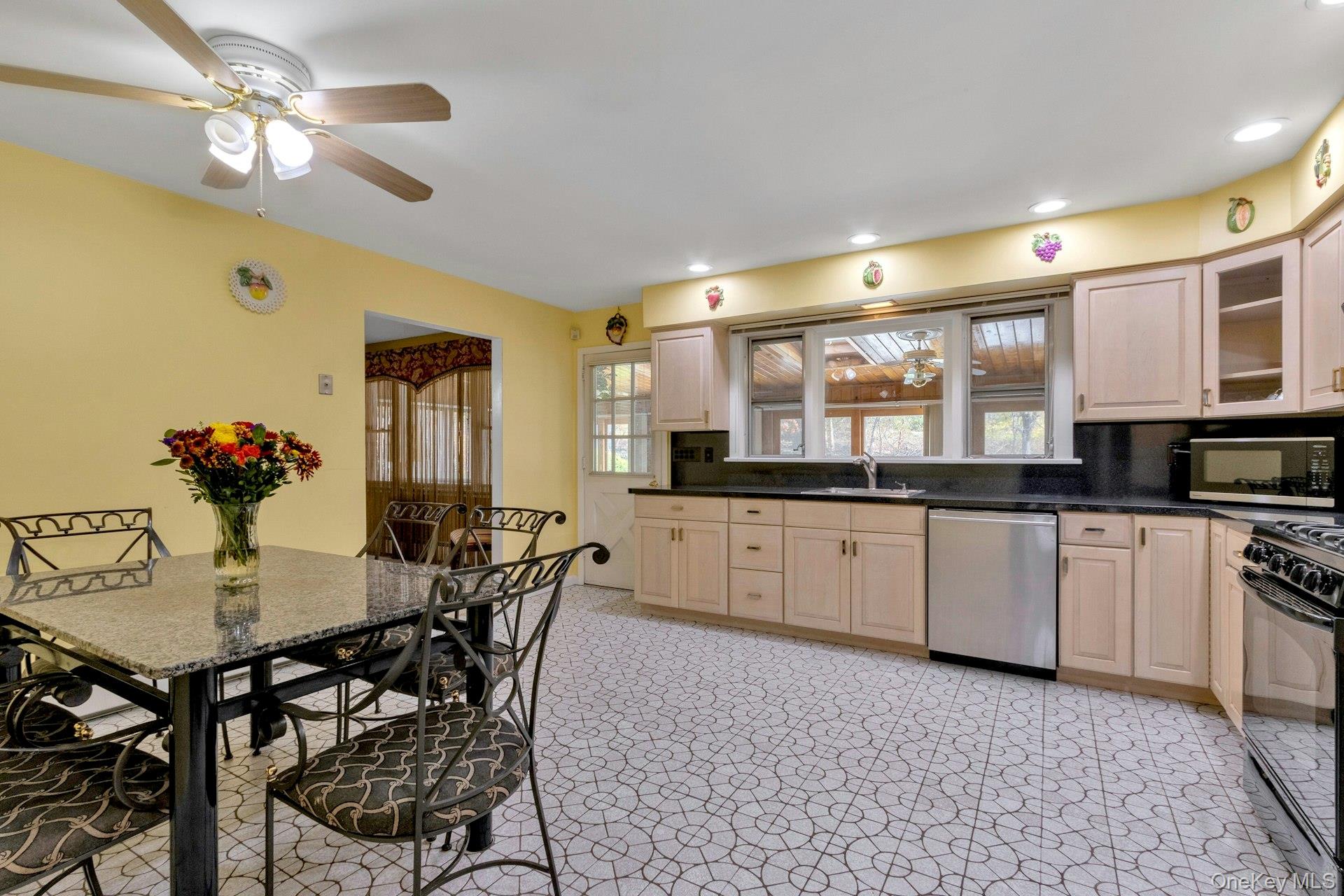 44 Greenridge Way Spring Valley, NY 10977 - Photo 13 of 46 a kitchen with stainless steel appliances granite countertop a dining table chairs and a refrigerator