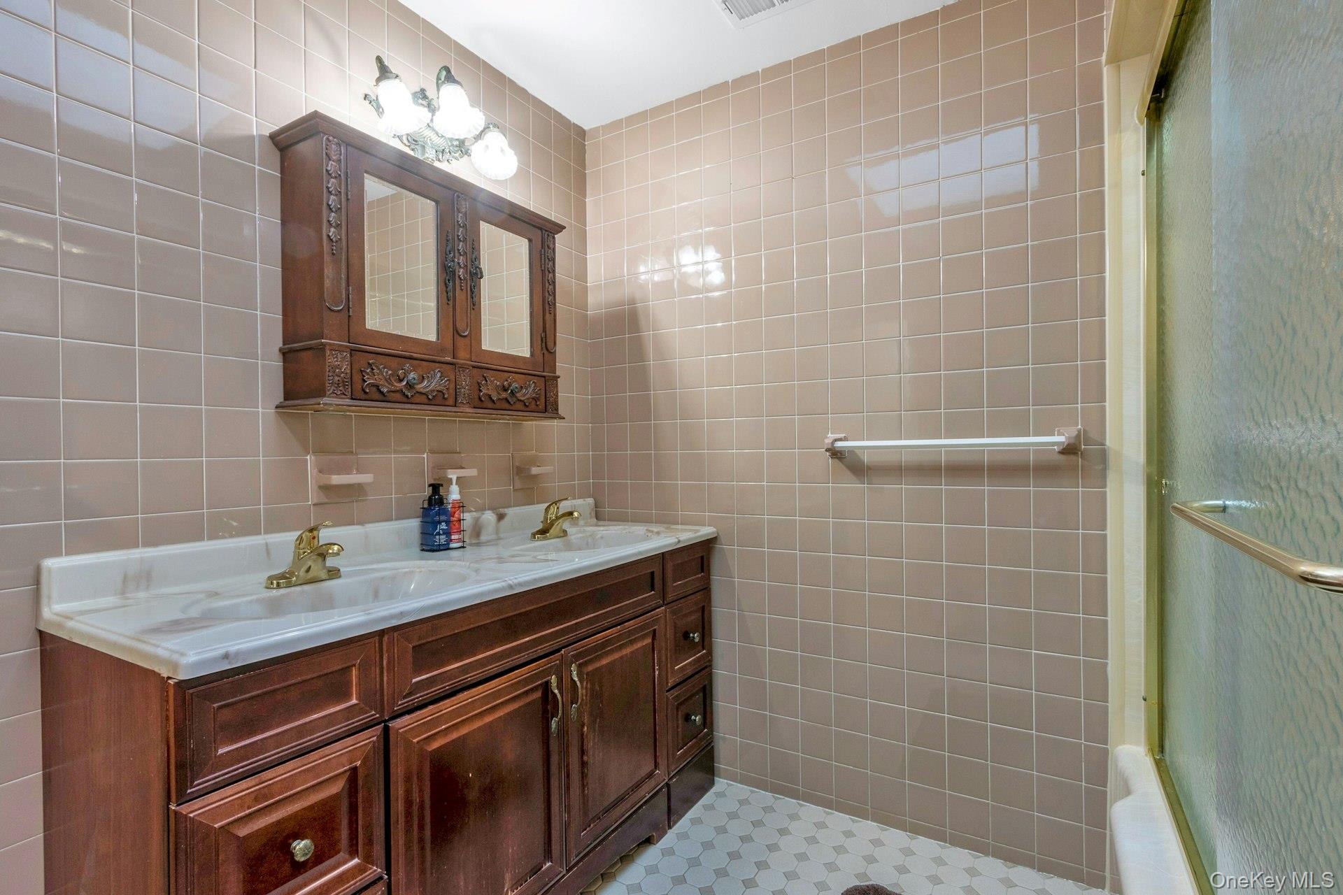 44 Greenridge Way Spring Valley, NY 10977 - Photo 19 of 46 a bathroom with a sink a vanity and a mirror