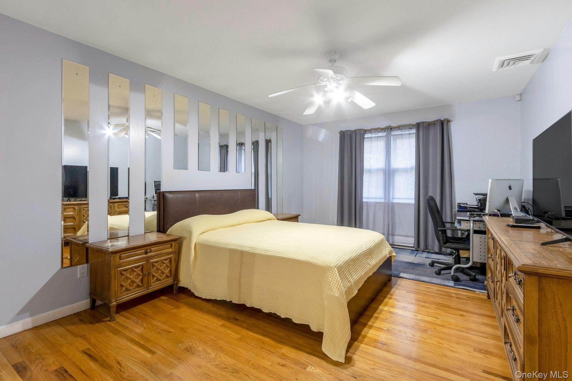 44 Greenridge Way Spring Valley, NY 10977 - Photo 22 of 46 a spacious bedroom with a bed and a chandelier