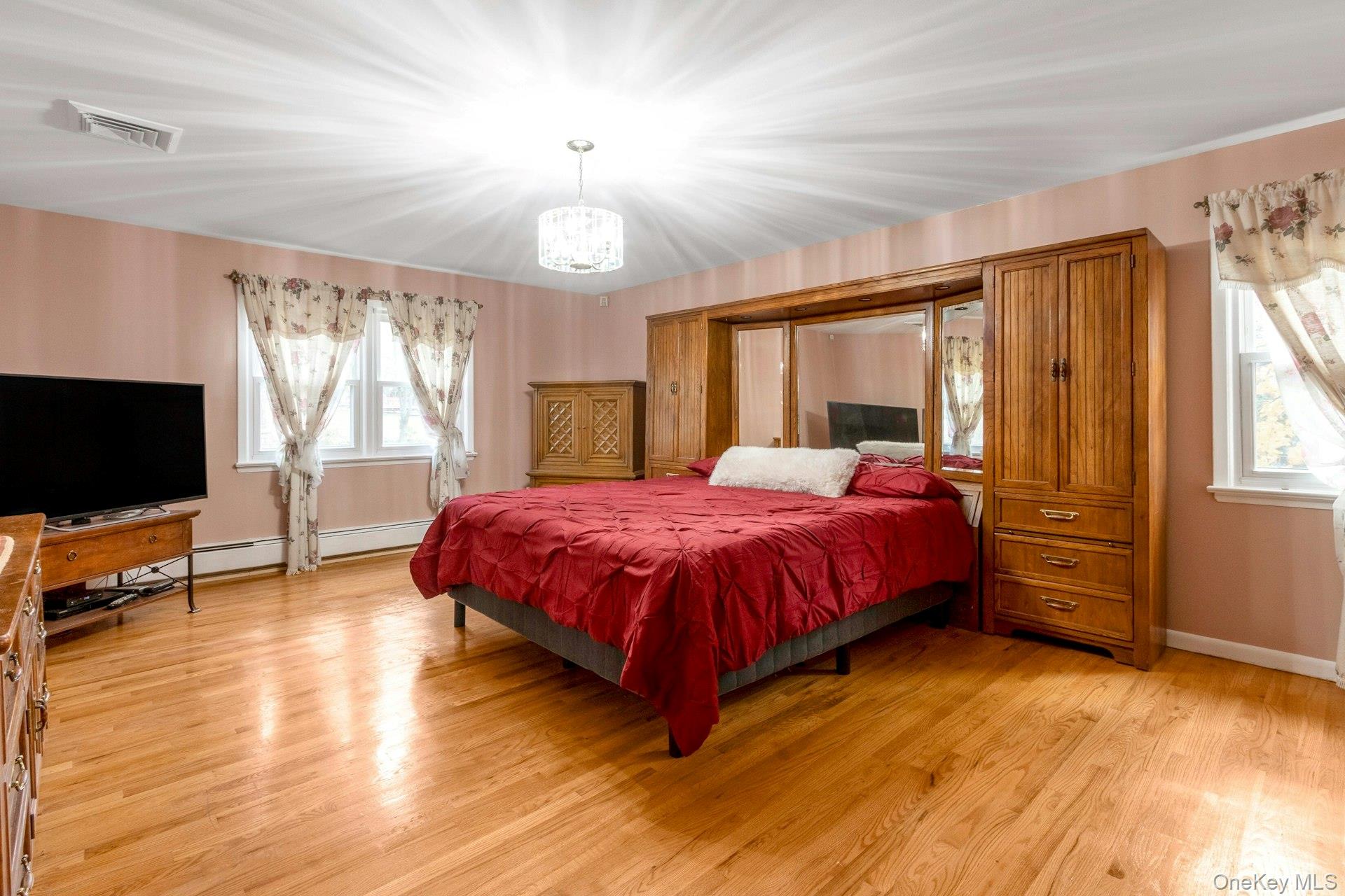 44 Greenridge Way Spring Valley, NY 10977 - Photo 23 of 46 a spacious bedroom with a bed and wooden floor