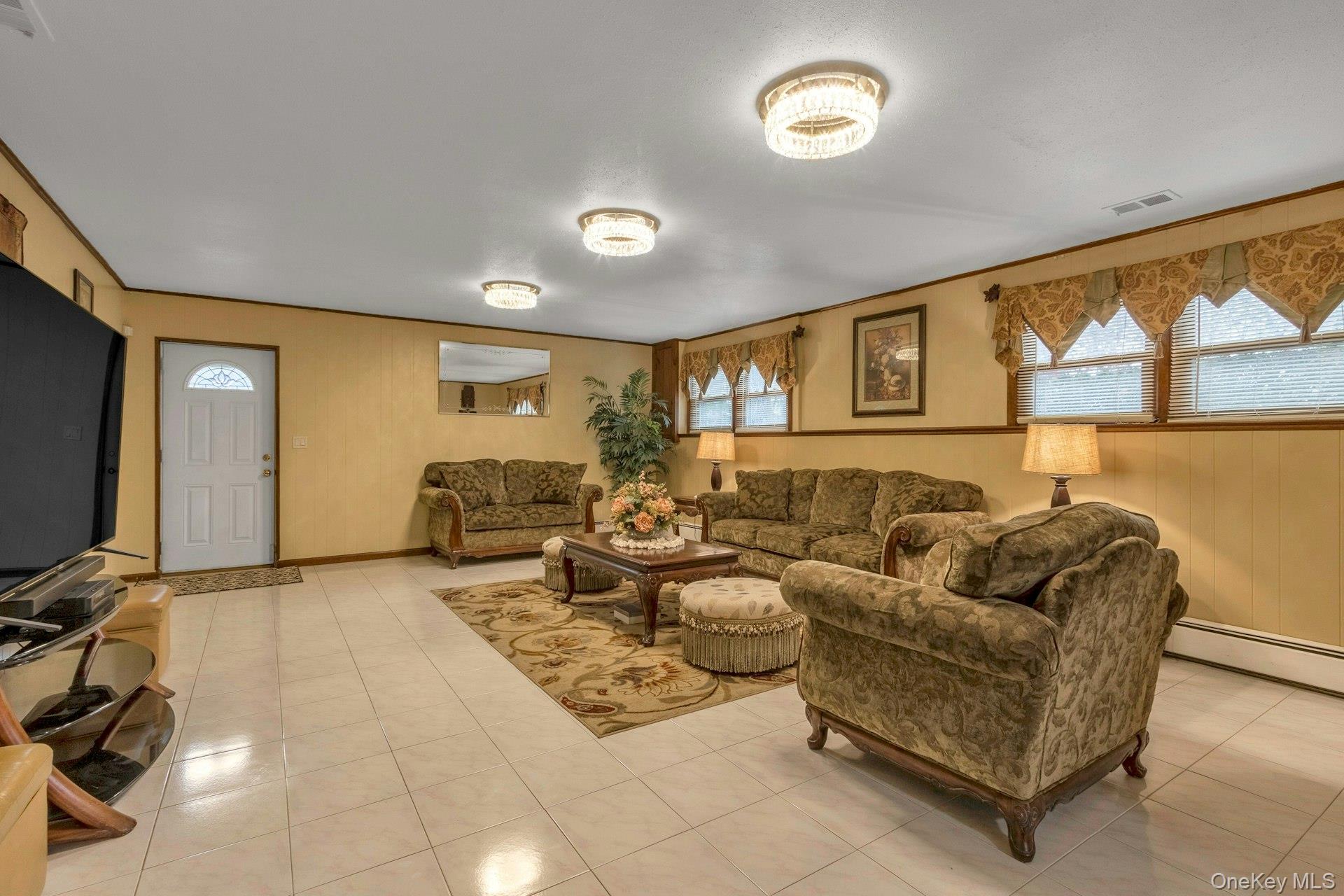 44 Greenridge Way Spring Valley, NY 10977 - Photo 29 of 46 a living room with furniture and a flat screen tv