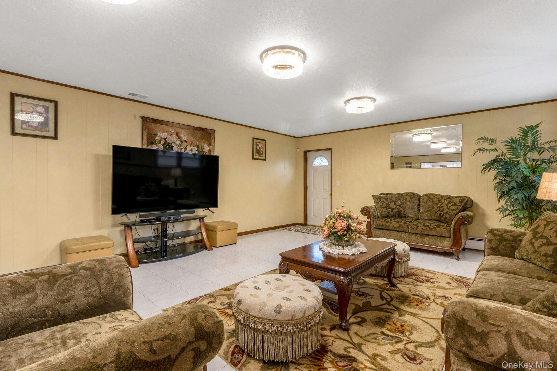 44 Greenridge Way Spring Valley, NY 10977 - Photo 30 of 46 a living room with furniture and a flat screen tv