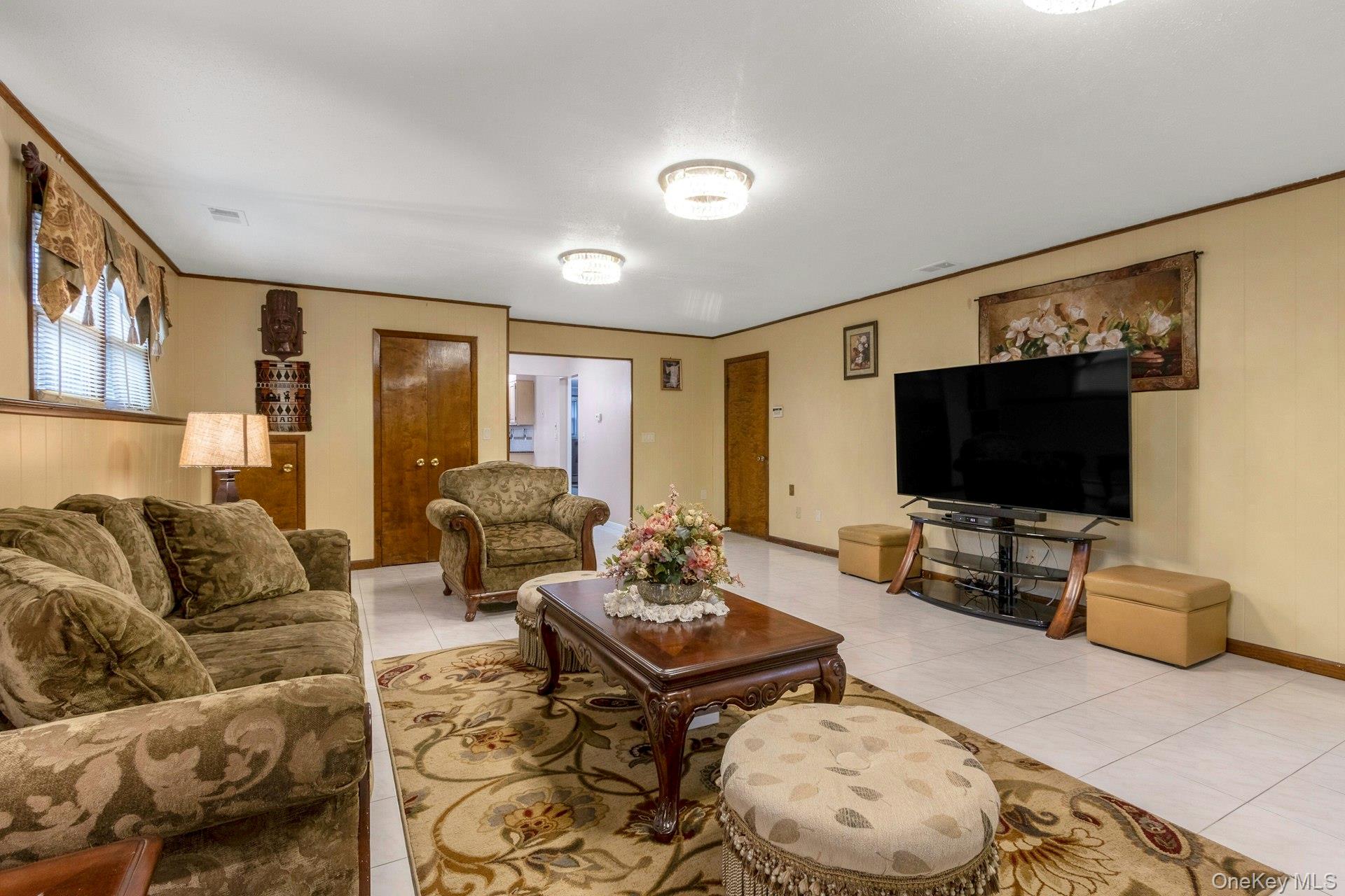 44 Greenridge Way Spring Valley, NY 10977 - Photo 32 of 46 a living room with furniture and a flat screen tv