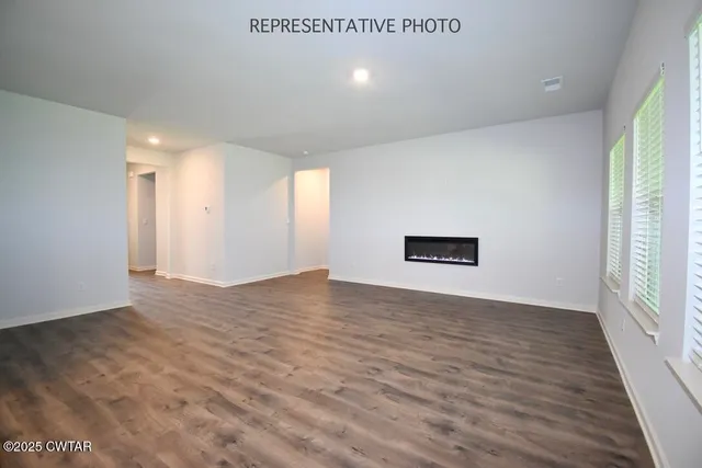 a view of room with window and wooden floor