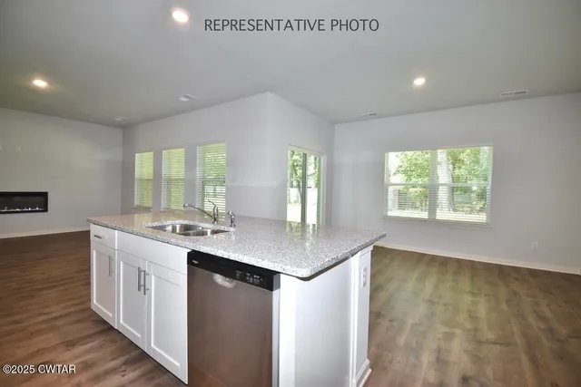 a kitchen with a sink stove and cabinets