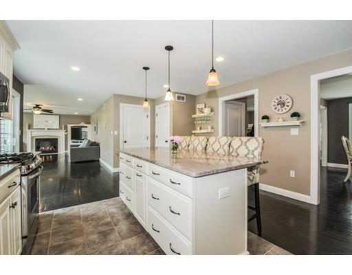 3 Hannon Road Billerica, MA 01862 - Photo 11 of 30 a kitchen with granite countertop a stove and white cabinets