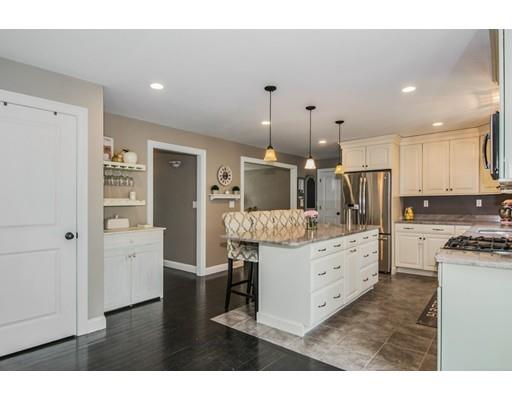 3 Hannon Road Billerica, MA 01862 - Photo 7 of 30 a kitchen with white cabinets and stainless steel appliances