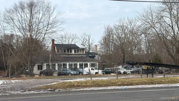 a front view of residential houses with yard and trees