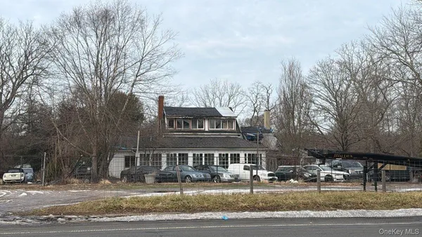 a front view of residential houses with yard and trees