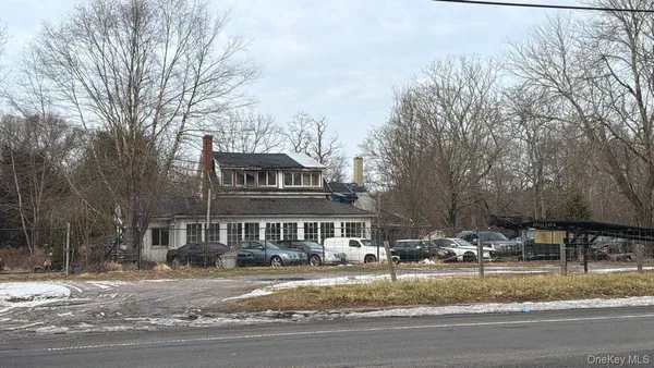 a front view of residential houses with yard and trees