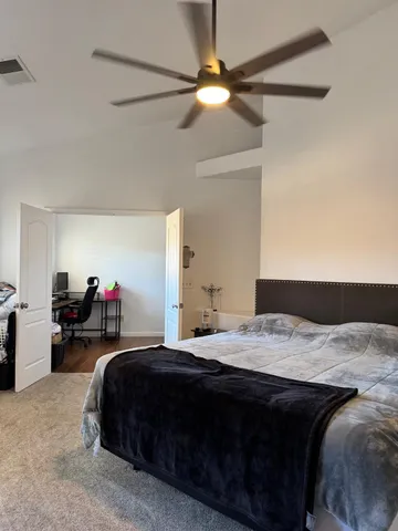 a bedroom with bed and a chandelier