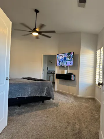 a bed sitting in a bedroom and table