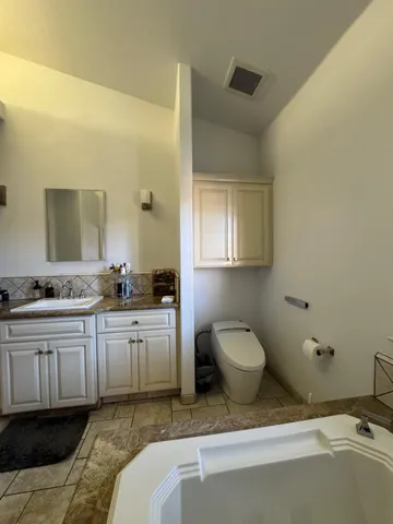 a bathroom with double sink and a mirror