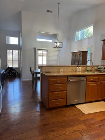 a kitchen with stainless steel appliances granite countertop a stove a sink and a microwave