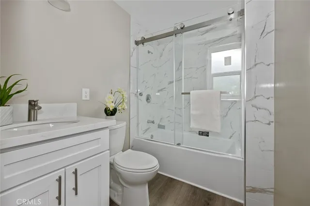 a bathroom with a shower a sink a toilet and shower