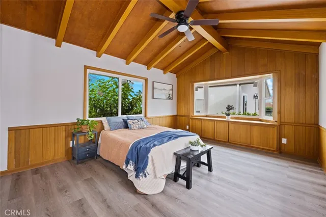 a bedroom with a bed and a view of kitchen