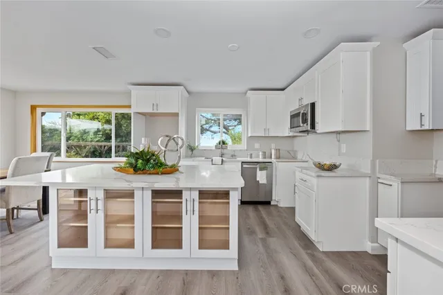 a kitchen with stainless steel appliances granite countertop a stove a sink dishwasher and a refrigerator