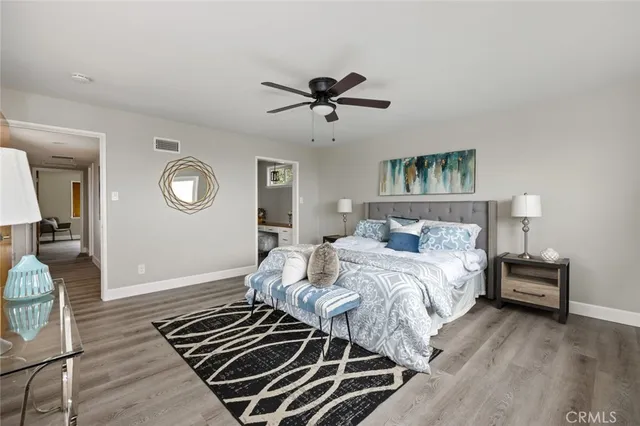 a bedroom with a bed and wooden floor