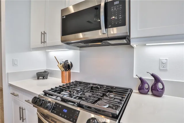 a kitchen with a stove and a microwave