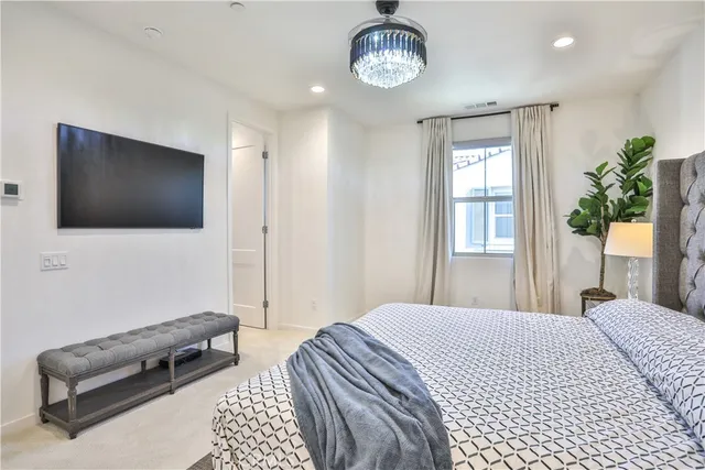 a bedroom with a bed and a flat screen tv