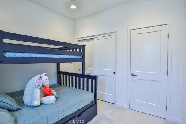 a bathroom with a granite countertop sink mirror vanity and toilet