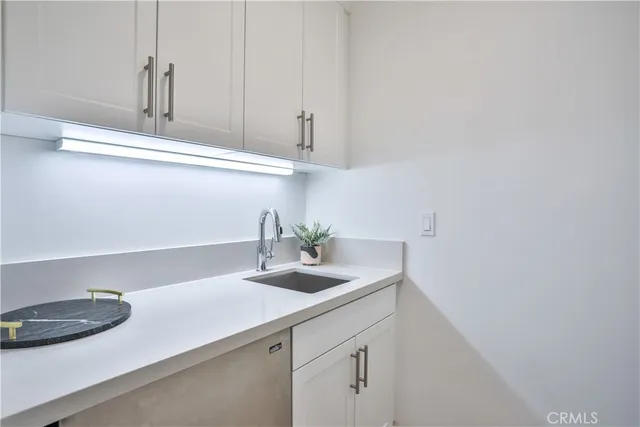 a kitchen with a sink and cabinets